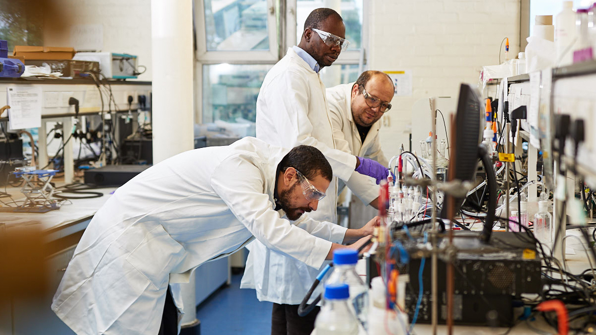 3 researchers in the lab conducting experiments